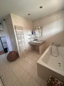 a white bathroom with a tub and a sink at La Casa San Biaggio in Ajaccio