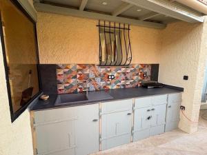 a kitchen with a sink and a counter top at La Casa San Biaggio in Ajaccio