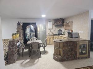a kitchen with a table and a kitchen with a refrigerator at Beach Apartment c in Sousse
