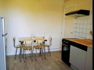 a kitchen with a table and chairs in a room at Appartement en Corrèze in Le Lonzac