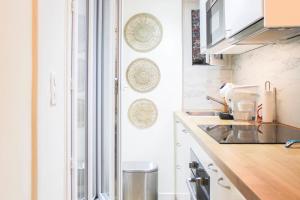 a kitchen with a sink and a counter top at bright studio with balcony quiet location in Paris