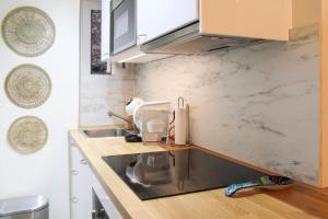 a kitchen with a sink and a counter top at bright studio with balcony quiet location in Paris
