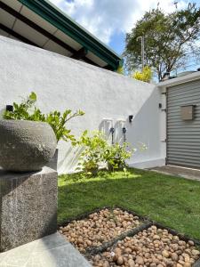 a garden with a stone wall and a stone bowl at Two Bedroom Villa Tangalle in Tangalle