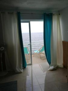 a room with a door with a view of the ocean at Loft en Callao Salvaje con Piscina y Vistas al Mar in Callao Salvaje