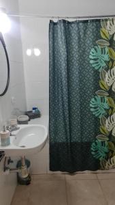a bathroom with a shower curtain and a sink at Loft en Callao Salvaje con Piscina y Vistas al Mar in Callao Salvaje