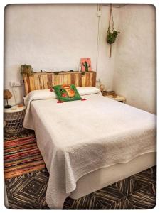 a bedroom with a large bed with a white blanket at Casa Maibeca in Bolbaite
