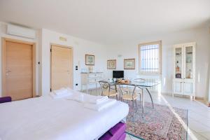 1 dormitorio blanco con 1 cama y comedor en Residenza Pastrengo, en Pastrengo 126 fotos más