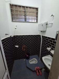 a bathroom with a toilet and a sink at Maryam Homestay Paka in Paka