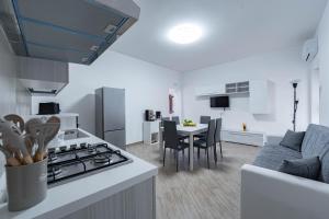 a kitchen and living room with a stove and a table at A casa dei nonni in Scala