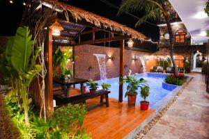 a courtyard with a swimming pool in a building with plants at Serena Tam Coc Hotel & Villa in Ninh Binh