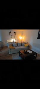 a living room with a couch and a table at Słoneczny Zakątek b in Złotów
