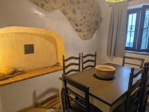a dining room with a table with a bowl on it at Casa L'Olivar in Beniardá
