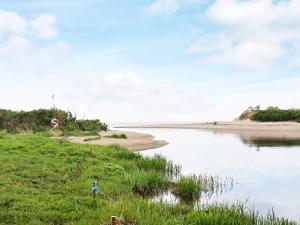 a stop sign next to a body of water at 4 person holiday home in Heberg in Heberg