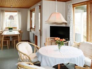 a living room with a table and chairs and a tv at 4 person holiday home in Heberg in Heberg +26 photos