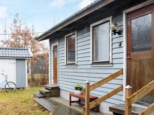 a tiny house with a porch and a wooden door at 4 person holiday home in Heberg in Heberg