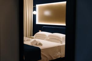 a bedroom with a bed with white sheets and pillows at SetSail in Vibo Valentia Marina