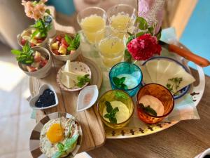 a table topped with bowls of food and drinks at Esmaraldas House of Love in Terrasini