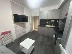 a small kitchen with a sink and a counter at Нощувки Шумен in Shumen