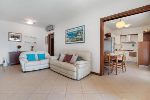 a living room with a couch and a dining room at Casa Andrea in Mestre