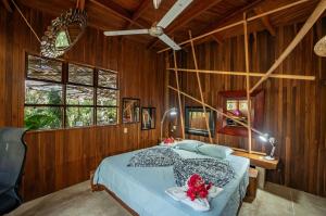 a bedroom with a bed in a wooden wall at Samara Tarantela, Treehouse in Sámara