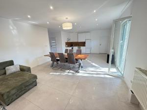 a dining room and living room with a table and chairs at Balia Apartament in Grudziądz