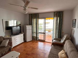 a living room with a couch and a television at Piso Torrox Costa Málaga in Torrox