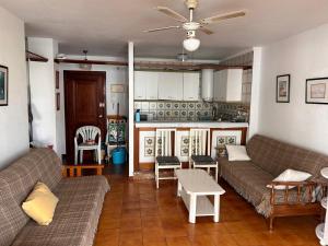 a living room with two couches and a kitchen at Piso Torrox Costa Málaga in Torrox