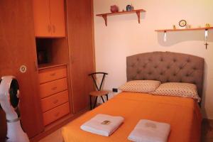a bedroom with a bed with two towels on it at B&B Corapi in Rome