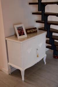 a white dresser with a picture and a box on it at Riverhouse in Kandern