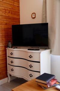 a television on a dresser with a tv on top at Riverhouse in Kandern +25 photos