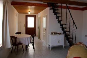 a dining room with a table and a spiral staircase at Riverhouse in Kandern