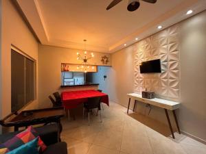 a dining room with a red table in a room at CASA Vila Braz - Pirassununga, SP in Pirassununga