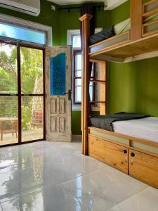 a bedroom with a bunk bed and a door at Habibi Hostel & Restaurant in Unawatuna +65 photos