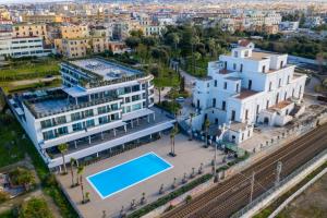 an aerial view of a building with a swimming pool at Hotel & Resort Tre Fontane Luxury in Portici