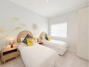 a bedroom with two beds and a window at Coastal Bliss Getaway Awaits! in Keurboomstrand +27 photos