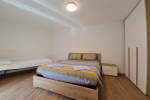 a bedroom with a bed in a white room at Cà di Sgarei TA in Nona