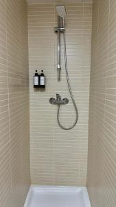a shower in a bathroom with a tub and a sink at Nomad Haux in the heart of Tossa 9 in Tossa de Mar