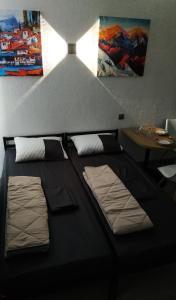 a black bed with two pillows and a table at Нові апартаменти 2 поверх, поруч лікарня та парк Феофанія, МХП in Kyiv