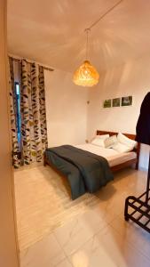 a bedroom with a bed and a chandelier at Cozy Corner 1 in Flic-en-Flac +21 photos