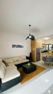 a living room with a couch and a table at Cozy Corner 1 in Flic-en-Flac