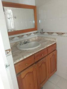 a bathroom with a sink and a mirror at APARTAMENTO RODADERO MAR ARRECIFES In in Rodadero