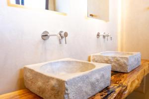 a bathroom with two marble sinks on a counter at Giardini di Marzo Lecce B&B in Lecce +80 photos