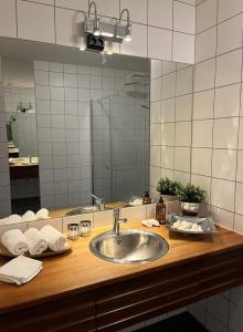 a bathroom with a sink and a large mirror at Arctic magic in the heart of Tromsø in Tromsø