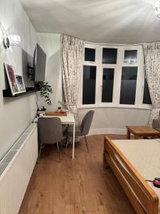 a bedroom with a desk and a bed and a table at Luxe Comfort En-Suite Room 1 in Oxford