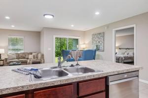 a kitchen with a sink and a living room at Isabella Ct Townhome in Orange Park