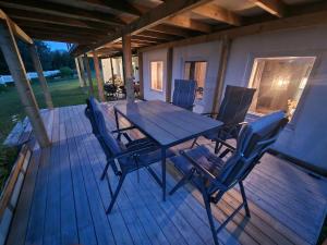 a wooden deck with a table and chairs on it at Mountainview apartment in Storsteinnes