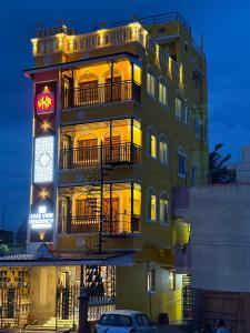 a yellow building with a krispy kreme sign on it at Lake View Residency in Puducherry