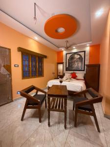 a bedroom with a bed and a table and chairs at Lake View Residency in Puducherry +7 photos