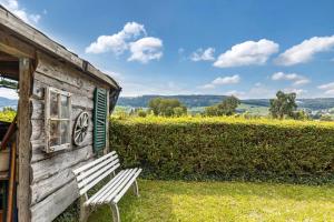a wooden building with a bench in front of it at Gita in Öhningen