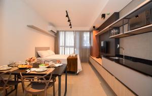 a kitchen and a living room with a dining room at Viva Trindade - CEN009 in Florianópolis